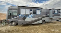 An RV parked at Burning Man, with the words, "It's a Girl!"