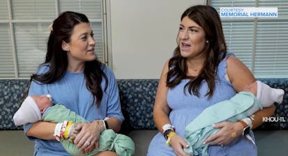 Lindsey and Rachel, identical twin sisters, hold their newborn sons.