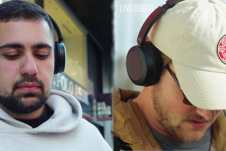 Screenshots: Live Action Two men wearing headphones watch a video separately