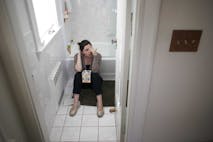 Photo: Getty Images Pregnant Woman Sitting on Bathroom Floor with Box of Tissues between Knees
