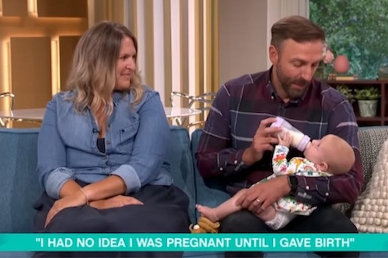 Baby Olivia visits The Morning Show with her parents, Helen and Michael Helen watches as Michael feeds baby Olivia her bottle.