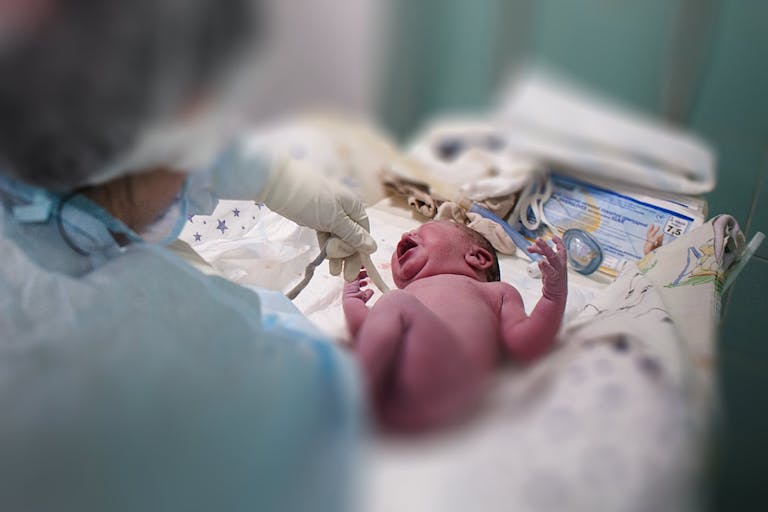 Photo by Anastasia Vlasova/Getty Images KYIV, UKRAINE - MARCH 30: A doctor and a nurse inspect a newborn boy in the maternity hospital on March 30, 2022 in Kyiv area, Ukraine. An estimated half of greater Kyiv's 3.5 million people have fled since the start of Russia's invasion, the capital's mayor said earlier this month.
