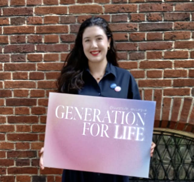woman holds pro-life sign