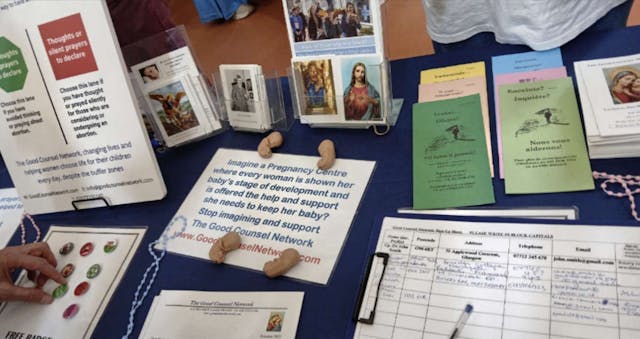 table featuring fetal models, pro-life brochures