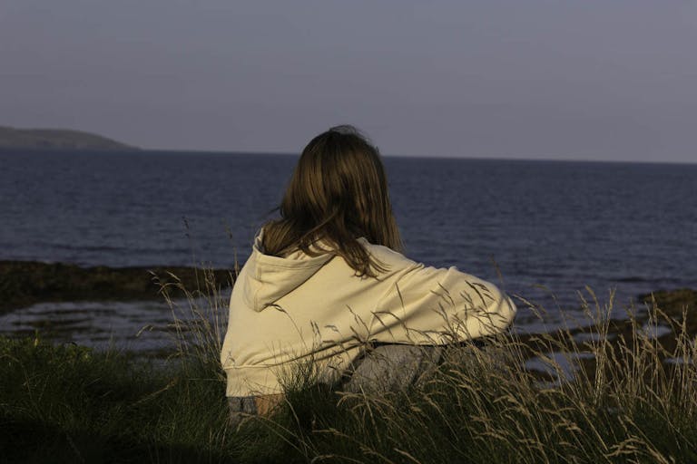 A teenager looking out to sea