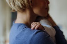 Close up of mother holding and cuddling her baby