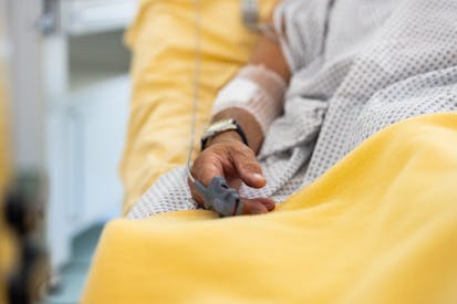 Close-up of a male patient's hand in a hospital bed with oximeter. Senior man admitted hospital.
