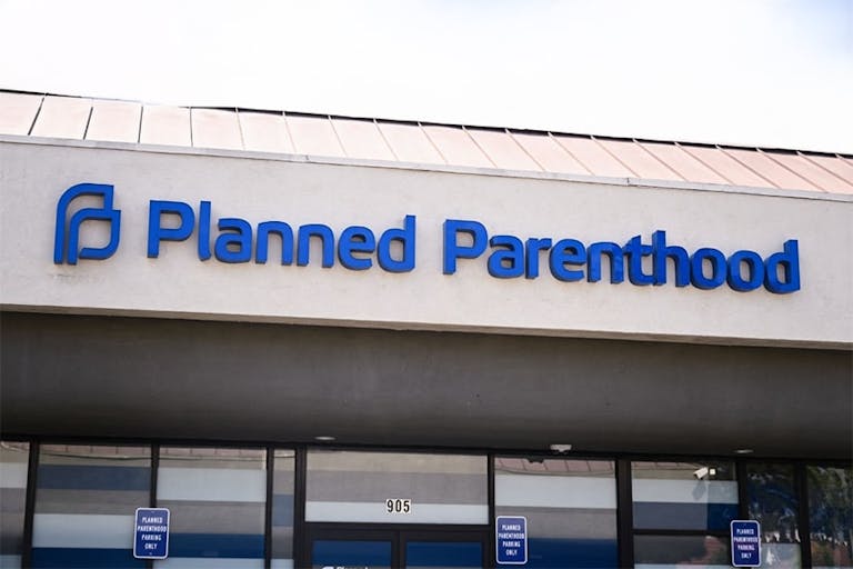 Photo by PATRICK T. FALLON/AFP via Getty Images Planned Parenthood sign, California