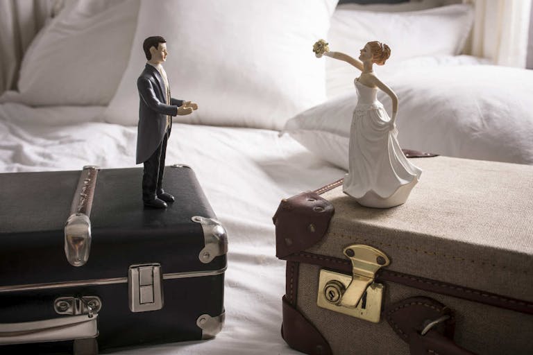 Photo: David Cleveland/Getty Images Wedding figurines on separate suitcases