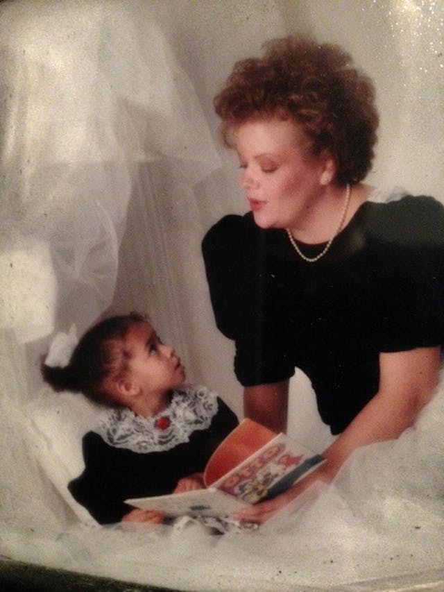 Kim with daughter Andee (Photo courtesy of Kim Elliot) Kim and her young daughter look at each other in front of a white background
