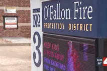 Screenshot: KMOV screenshot of safe haven baby box next to O'Fallon Fire Protection District sign