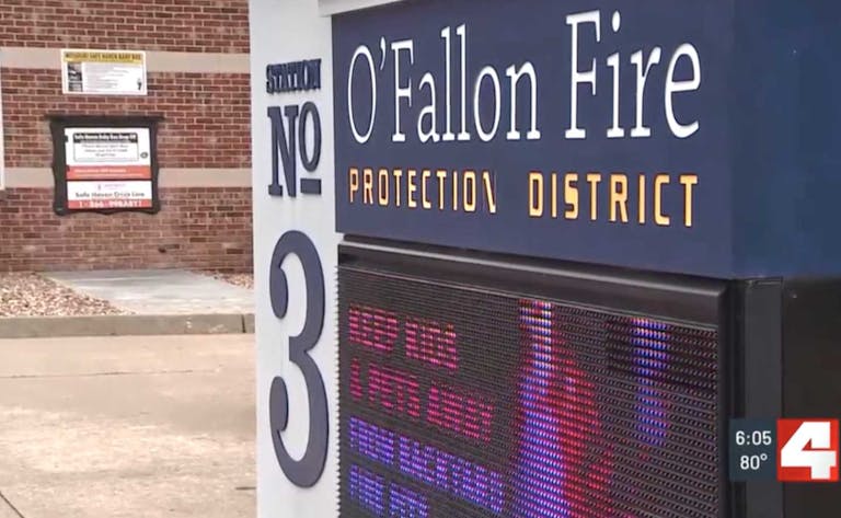 screenshot of safe haven baby box next to O'Fallon Fire Protection District sign
