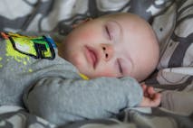 Photo: Tatiana Dyuvbanova / EyeEm via Getty Images Close-Up Of Baby With Down Syndrome Sleeping On Bed