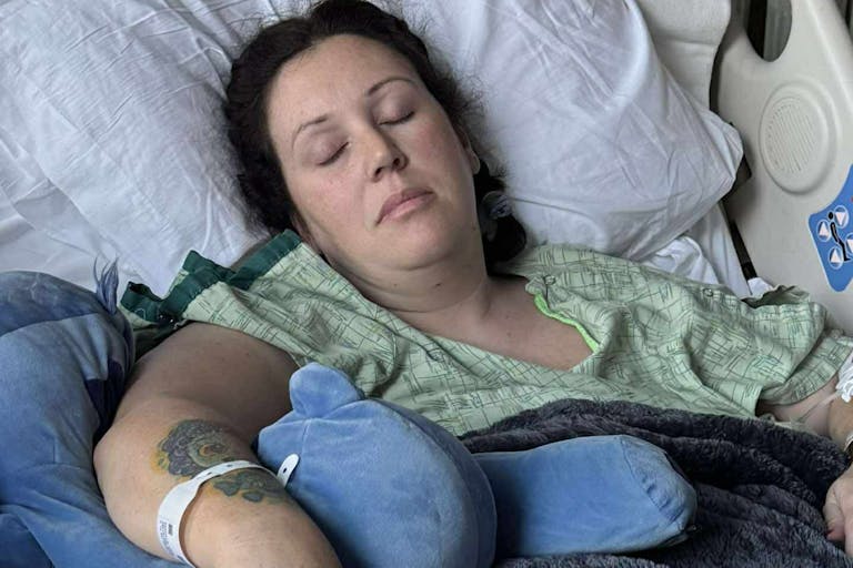 Photo credit: GoFundMe woman in hospital bed recovering from jumping out second story window