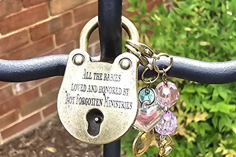 Padlock featuring writing that honors babies, lists Not Forgotten Ministries