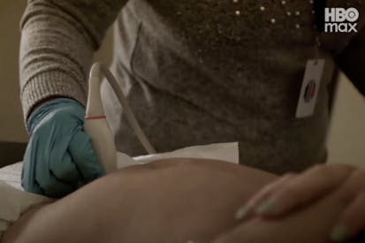abortion clinic worker wears a glove and performs abdominal ultrasound