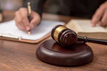 Male lawyer working with contract papers and wooden gavel on tabel in courtroom. justice and law ,attorney, court judge, concept. - stock photo Male lawyer working with contract papers and wooden gavel on tabel in courtroom. justice and law ,attorney, court judge, concept.