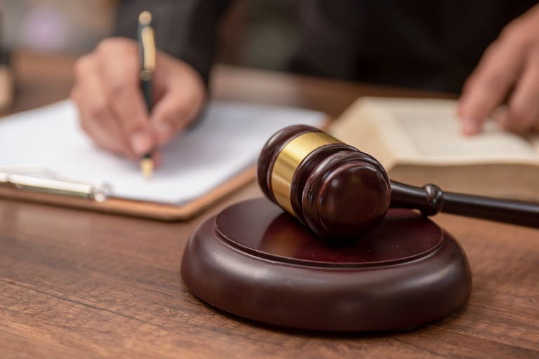 Male lawyer working with contract papers and wooden gavel on tabel in courtroom. justice and law ,attorney, court judge, concept. - stock photo Male lawyer working with contract papers and wooden gavel on tabel in courtroom. justice and law ,attorney, court judge, concept.