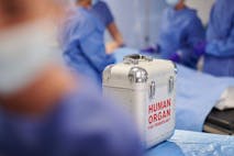 Stock Photo shows a silver briefcase labeled "human organ for transplant" in a medical operating theatre.