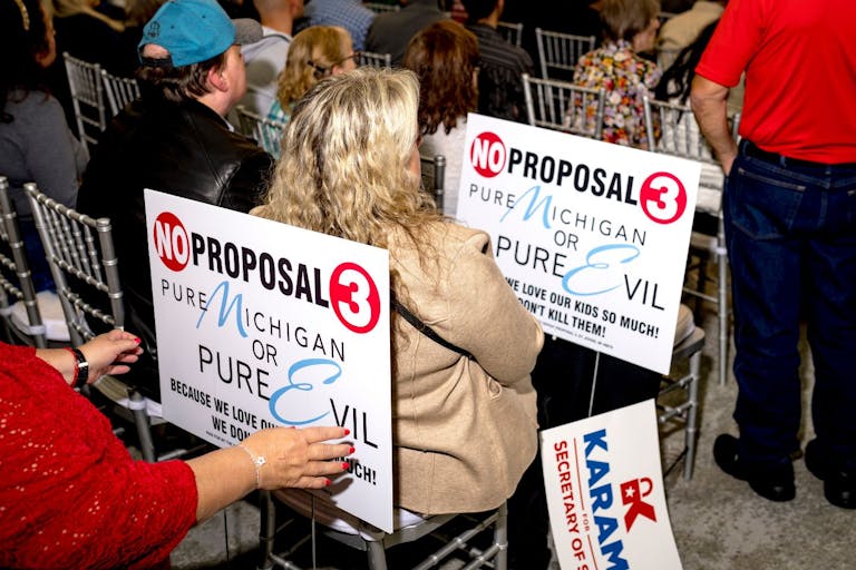 Photo: Nic Antaya for The Washington Post via Getty Images DEARBORN, MI - October 30: Signs in opposition of Proposal 3 are pictured during the Unite America rally at Fairlane Banquet Center in Dearborn, Michigan on October 30, 2022.