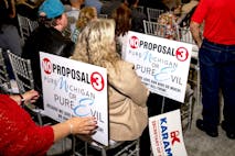 DEARBORN, MI - October 30: Signs in opposition of Proposal 3 are pictured during the Unite America rally at Fairlane Banquet Center in Dearborn, Michigan on October 30, 2022.