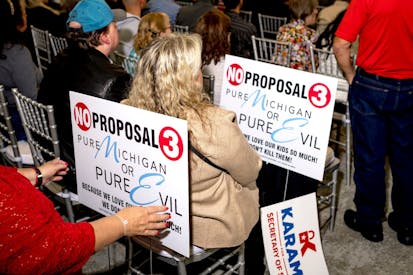 DEARBORN, MI - October 30: Signs in opposition of Proposal 3 are pictured during the Unite America rally at Fairlane Banquet Center in Dearborn, Michigan on October 30, 2022.