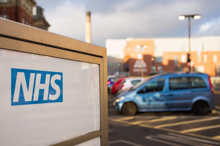 Photo: George Clerk/Getty Images Newcastle, UK - February 10, 2016: The NHS (National Health Service) logo on an entrance sign for the Royal Victoria Infirmary, a teaching hospital which includes an accident and emergency department.