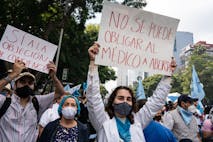 MEXICO CITY, MEXICO - 2021/10/03: A demonstrator holds a placard reading "You cannot force a doctor to abort" during the pro-life demonstration march. Thousands march in Mexico City at a pro-life and pro-women demonstration march. Demonstrators came in from all over the country, with different states or organizations written on their t-shirts. The march comes after the Mexican Supreme Court ruled that abortion is no longer a crime since September 2021.