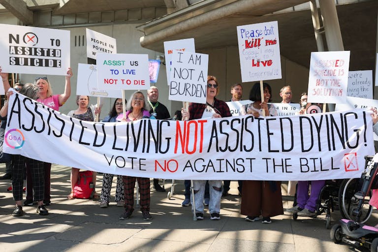 Photo: Jeff J Mitchell/Getty Images EDINBURGH, SCOTLAND - MAY 13: Opponents on the vote on the plans to legalise assisted dying demonstrate outside the Scottish Parliament to show support against Stage 1 of Scotland’s assisted dying bill on May 13, 2025 in Edinburgh, Scotland. MSPs are voting on whether or not to allow terminally ill adults to seek medical help to end their lives in the Scottish Parliament today.