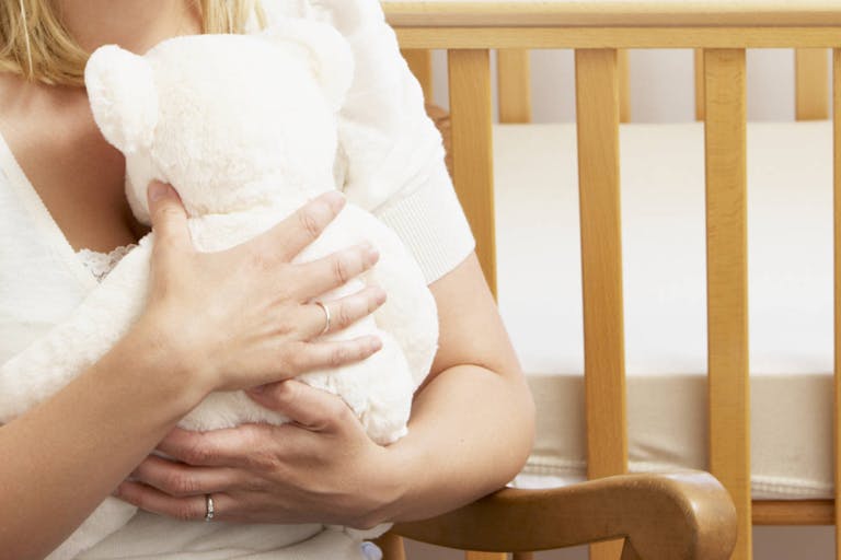 Photo: Getty Images/Monkey Business Sad Mother Sitting In Empty Nursery
