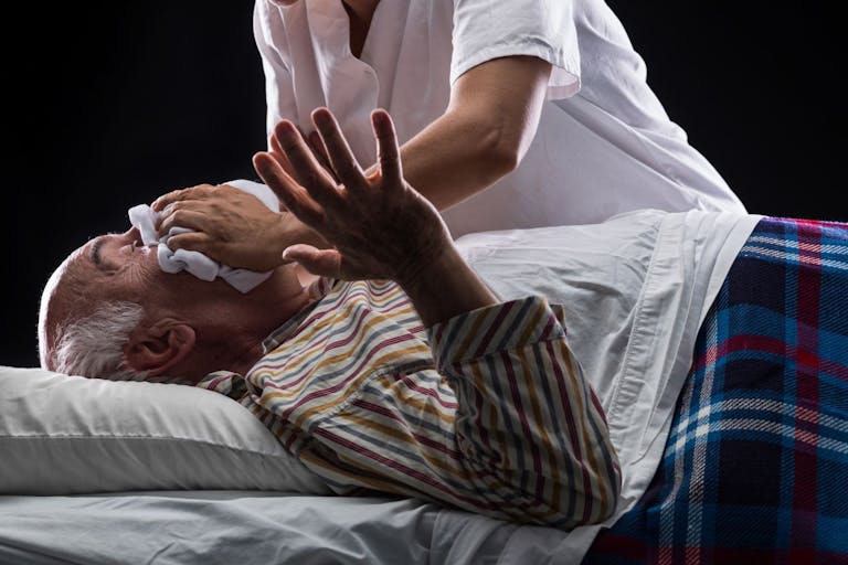 Getty Images Credit: Juanmonino Nurse trying to suffocate her patient to death while he is sleeping on black background