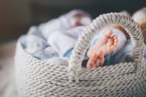 Photo: Marko Pekic/Getty Images Newborn baby boy laying in basket