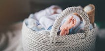 Newborn baby boy laying in basket