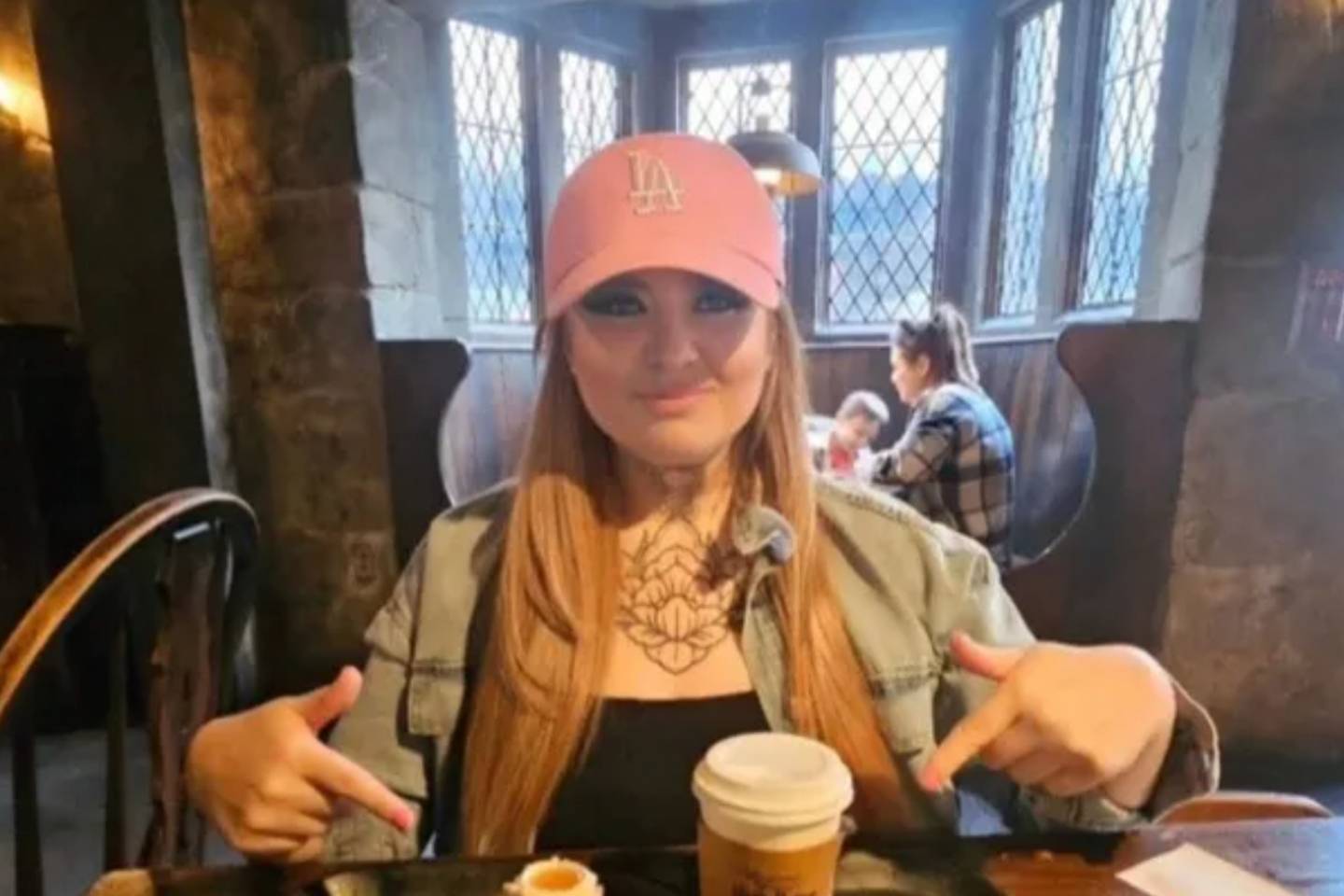 A photo shows June Bunyan in a pink LA Dodgers baseball hat at a restaurant.