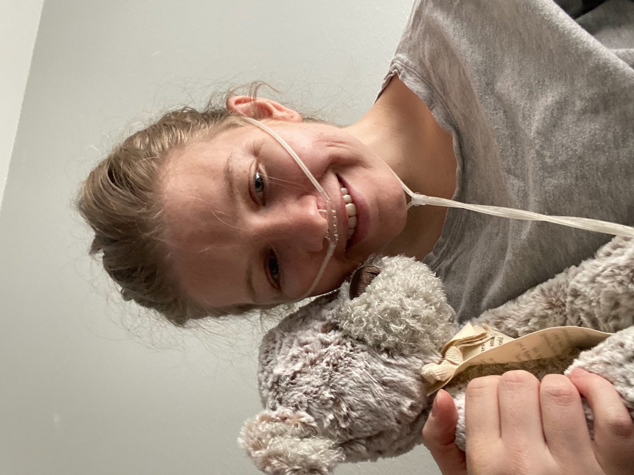 Jane Allen holds a teddy bear while wearing a nasal cannula while in hospice in 2020.