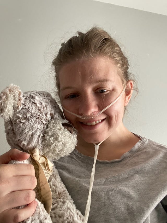 Jane Allen in hospice in 2020. Photo courtesy of her family. Jane Allen holds a teddy bear while wearing a nasal cannula while in hospice in 2020.