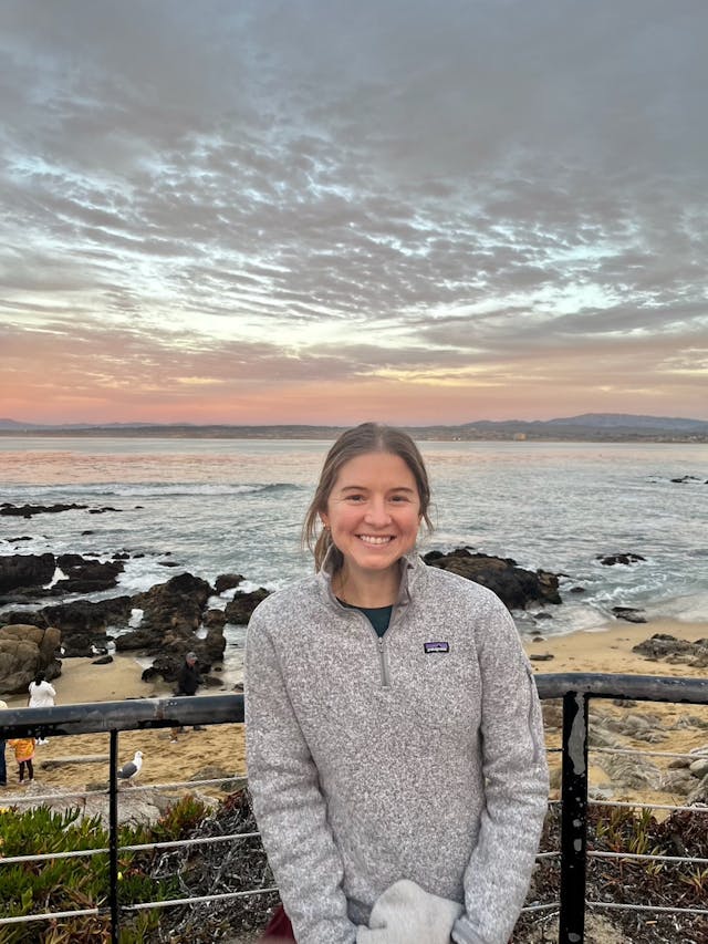 Jane Allen in 2023. Photo courtesy of the Allen family. Jane Allen smiles standing in front of a bay in 2023.