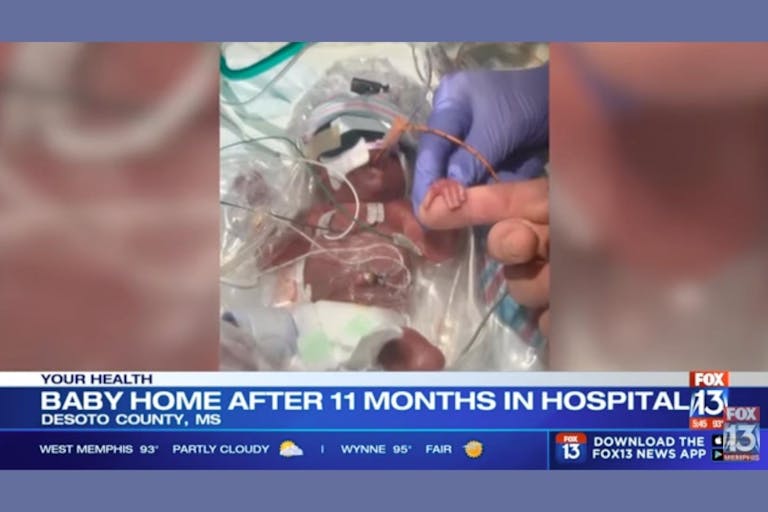 Photo via Fox News 13 video YouTube Premature baby boy in a NICU crib with tubing.