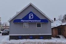 Screenshot from Change.org petition Planned Parenthood facility in Marquette, Michigan. Blue gray building with snow on the roof.