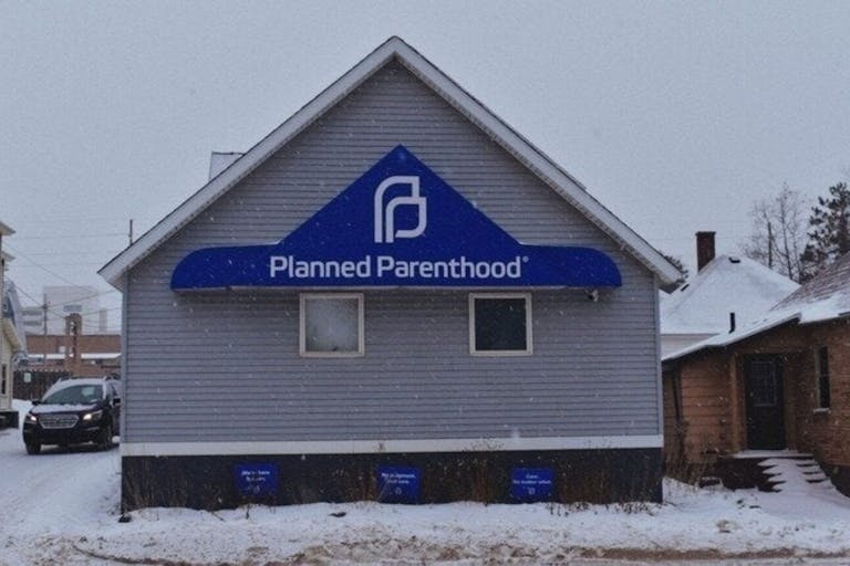 Screenshot from Change.org petition Planned Parenthood facility in Marquette, Michigan. Blue gray building with snow on the roof.