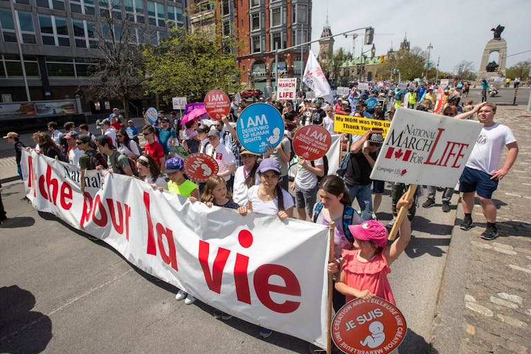 Photo by LARS HAGBERG/AFP via Getty Images Pro-life protesters march during the National March for Life in Ottawa, Ontario, on May 12, 2022. The protest comes amid a political firestorm in the United States ignited by a leaked draft opinion that showed the Supreme Court's conservative majority preparing to overturn Roe v. Wade, a landmark 1973 ruling guaranteeing abortion access nationwide.