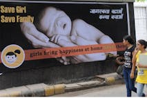 Photo: RAVEENDRAN/AFP via Getty Images Young Indian women walk past a billboard in New Delhi on July 9, 2010, encouraging the birth of girls. Mostly as a result of sex-selective abortion, India is one of the few countries worldwide with an adverse child sex ratio in favour of boys. Under Indian law, tests to find out the gender of an unborn baby are illegal if not done for medical reasons, but the practice continues in what activists say is a flourishing multi-million-dollar business. Girls in India are often considered a liability, as parents have to put away large sums of money for dowries at the time of their marriage.