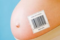 Pregnant woman's belly with barcode - stock photo