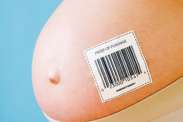 Pregnant woman's belly with barcode - stock photo