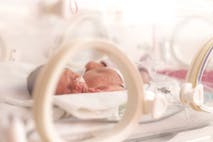 Photo (preemie, 33 weeks): Ondrooo/Getty Images Premature newborn  baby girl in the hospital incubator after c-section in 33 weeks