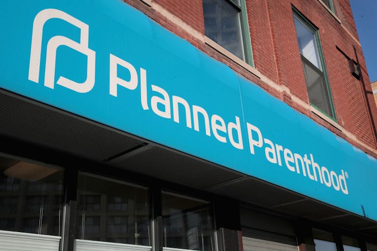 Photo by Scott Olson/Getty Images CHICAGO, IL - MAY 18: A sign hangs above a Planned Parenthood clinic on May 18, 2018 in Chicago, Illinois. The Trump administration is expected to announce a plan for massive funding cuts to Planned Parenthood and other taxpayer-backed abortion providers by reinstating a Reagan-era rule that prohibits federal funding from going to clinics that discuss abortion with women or that share space with abortion providers.
