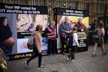Photo: Leon Neal/Getty Images LONDON, ENGLAND - OCTOBER 16: (EDITOR'S NOTE: Image depicts graphic content) Protestors attempt to cover images of an aborted foetus as young school children pass by, during an anti-abortion protest outside the Houses of Parliament on October 16, 2025 in London, England. The protest, organised by the Centre for Bio-Ethical Reform UK, was meant to coincide with a second reading in the House of Lords of the Crime and Policing Bill, which contains a provision that would end the threat of criminal prosecution for women who terminate their pregnancies at any point during gestation.
