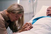 Photo: Sean Anthony Eddy/Getty Images Healthcare, senior man and sad woman in hospital for support, love and praying by bed. Terminal illness, family or holding hands with patient for grief, depression or anxiety for wellbeing in hospice