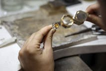 Close-up of an unrecognizable female Caucasian jeweler looking at a gemstone.