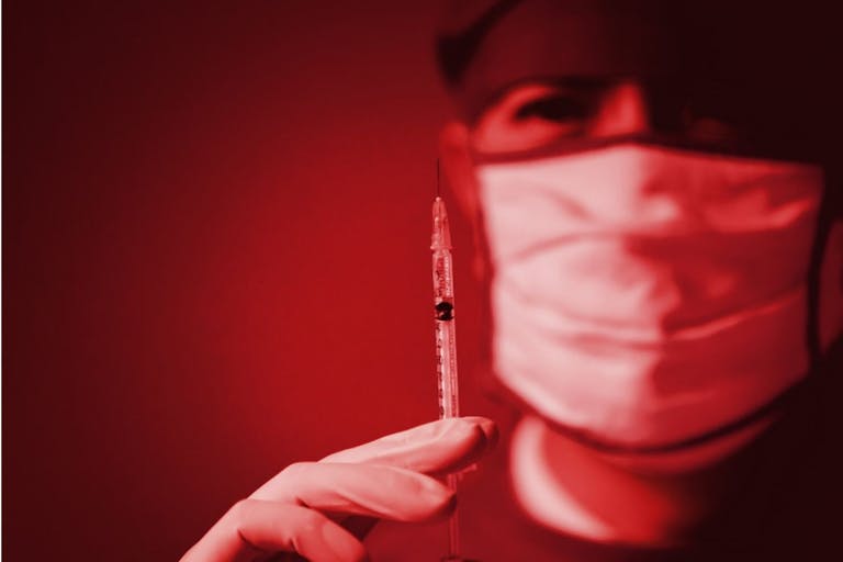Photo: Getty Images Wrong medication drug vaccine abuse silent dying danger kill patient lethal injection in hospital concept. Doctor holding syringe red color tone - stock photo